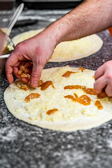 hand of chef baker making pizza at kitchen. The process of making pizza. cooking italian pizza