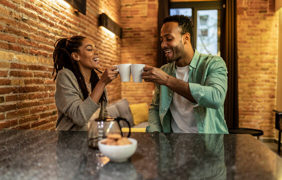 Lovely African Couple Drinking Coffee At Home