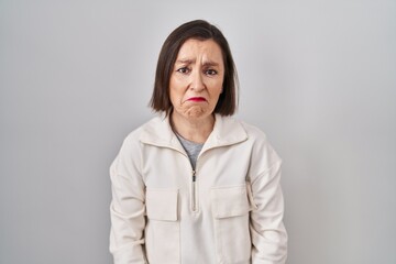 Obraz premium Middle age hispanic woman standing over isolated background depressed and worry for distress, crying angry and afraid. sad expression.
