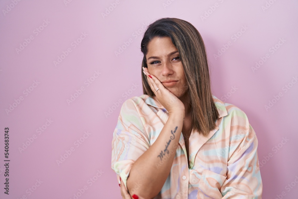 Canvas Prints Blonde woman standing over pink background thinking looking tired and bored with depression problems with crossed arms.