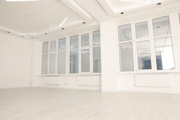 Fototapeta premium Modern office room with white walls and windows. Interior design