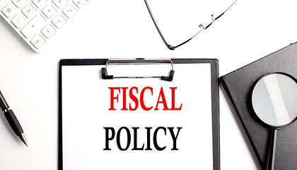 FISCAL POLICY text written on paper clipboard with office tools