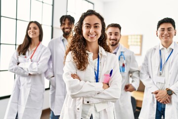 Fototapeta premium Group of young doctor smiling happy standing with arms crossed gesture at the clinic office.
