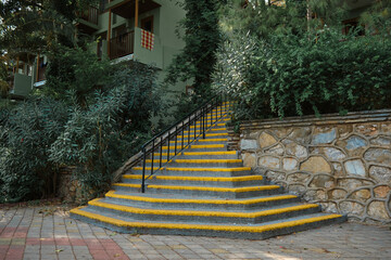 stairs with yellow stripes for people with poor eyesight