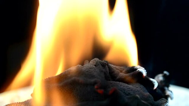 Slow Motion. Fabric and fire. Slow Motion. The burning