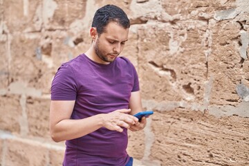 Young man using smartphone at street