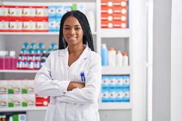 African american woman pharmacist smiling confident standing with arms crossed gesture at pharmacy