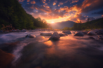 Fototapeta premium Magical sunset over fast flowing mountain river