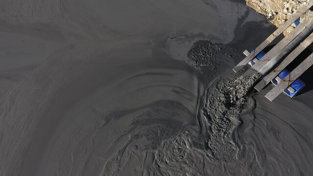 Aerial view of heavy metal contamination from a copper mine. Mining residual waters discharging into decanting pond. Geamana, Romania
