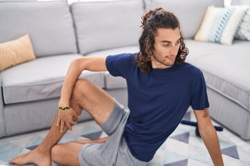 Fototapeta na wymiar Young hispanic man doing yoga exercise at home