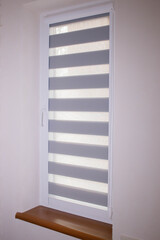 Window roller duo system day and night. Close up on roll curtains indoor.