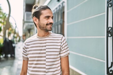 Young hispanic man smiling confident at street