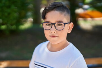 Fototapeta premium Adorable hispanic boy smiling confident standing at park