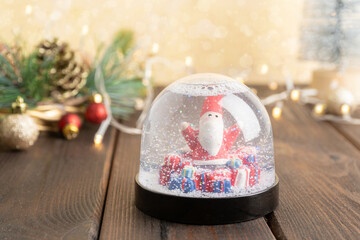 Snow globe with Santa Claus. Selective focus and Bokeh lights. Winter composition