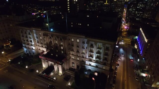 Aerial Backward Shot Of Illuminated Residential Buildings In City At Night - San Francisco, California