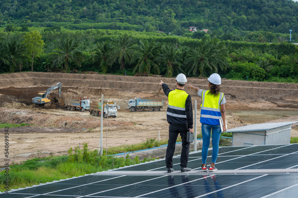 Poster Professional worker installing and checking solar panels on the roof of a factory,Innovative solution for energy solving. Use renewable resources. Green energy.
