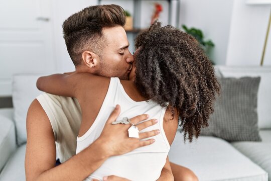 Man and woman couple kissing and hugging each other at home