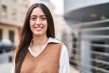 Young beautiful hispanic woman smiling confident standing at street