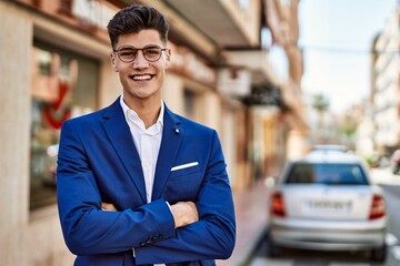 Young man smiling confident wearing suit and glasses at street
