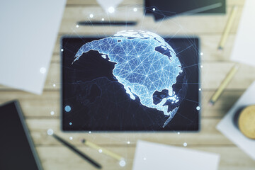 Digital America map and modern digital tablet on desktop on background, top view, global technology concept. Multiexposure