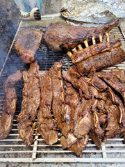 Vertical Image of a barbecue with pork ribs and meat on the grill