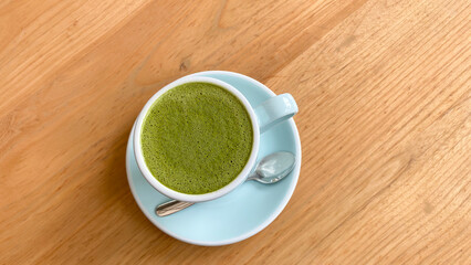 drink, diet, weight-loss and slimming concept - cup of matcha green tea latte over white