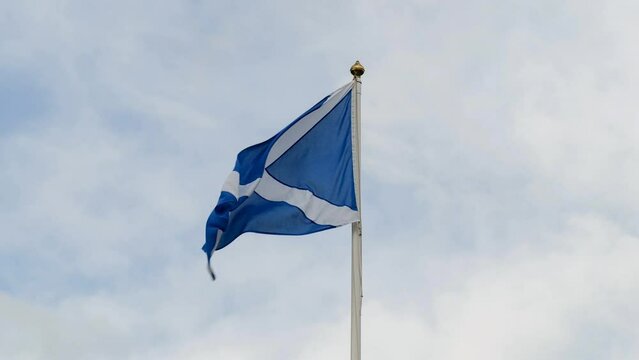 Detail of Scottish flag on a flagpole waving in a strong wind