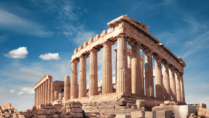 Fototapeta premium Parthenon temple in Acropolis in Athens, Greece. Panoramic image on a bright sunny day, blue sky with clouds.