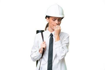 Young architect woman with helmet and holding blueprints over isolated background having doubts