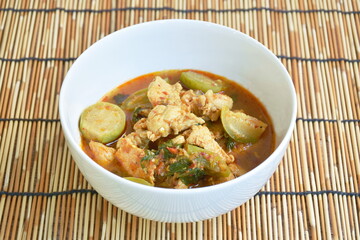 spicy boiled chicken with eggplant in curry soup on bowl