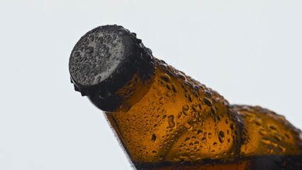 Brown condensate beer bottle closeup. Fresh hoppy ipa beverage flask with drops