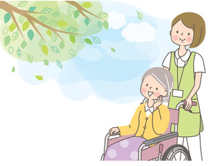 車椅子のシニア女性を介助する若い女性介護士