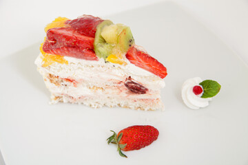 Tasty fruit cake slice on plate, decorated. Valentines or birthday party.