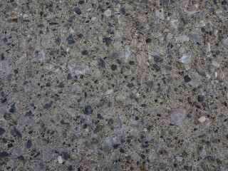 細かい青色系の小石が混ざった灰色のセメントのテクスチャー