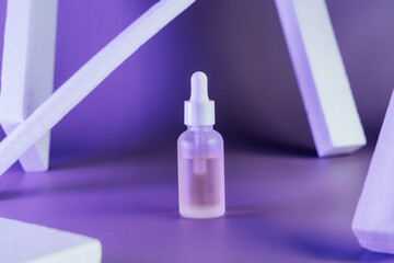 Oily serum in glass bottle with pipette on purple background with rectangle arch and columns , neon light with copy space. Modern and futuristic cosmetic mockup. Selective focus.