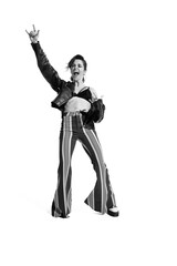 Portrait of beautiful young woman, rock music lover posing, dancing isolated over white background. Black and white photo