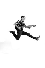 Fototapeta na wymiar Portrait of young emotive man in stylish clothes playing guitar, posing isolated over white background. Black and white photo