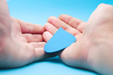 Hands holding a paper water drop on a blue background.
Concept save water, drought, world water day, hand sanitizer and hygiene, family washing hands, CSR, save water, clean renewable energy drop