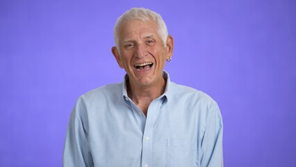 Portrait of a smiling laughing handsome middle aged man 70s. Mature caucasian man showing real emotions being happy, confident and likable. 