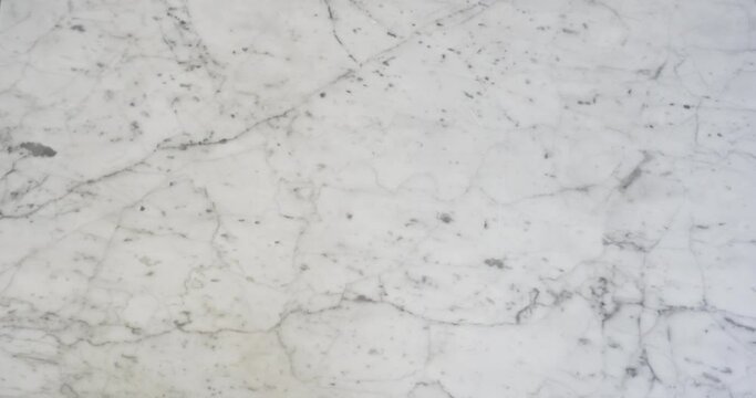 Closeup of pizza displayed on a marble table in a typical Italian restaurant in Paris.