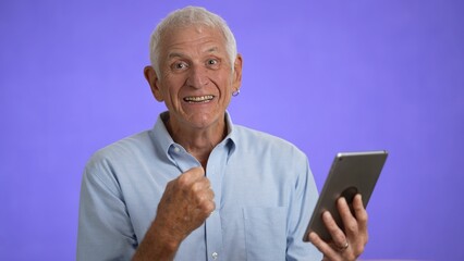 Animated elderly having video chat using digital tablet computer screen. Retired old man spend time talking to friends and family isolated on solid purple background