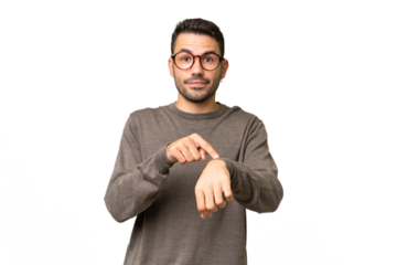 Young handsome caucasian man over isolated background making the gesture of being late