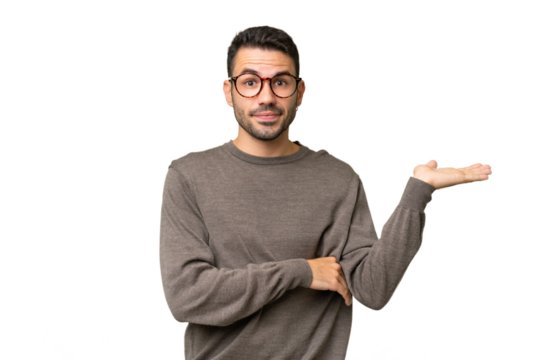 Young handsome caucasian man over isolated background having doubts