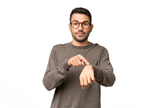 Young handsome caucasian man over isolated background making the gesture of being late