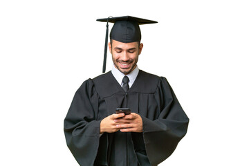 Young university graduate man over isolated background sending a message with the mobile