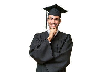 Young university graduate man over isolated background with glasses and smiling
