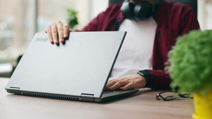Tired office worker finishes work, takes a break, closes laptop. Overworked developer ends working day in coworking, goes home. Freelancer ends project, leaves workplace with eyeglasses for lunch.