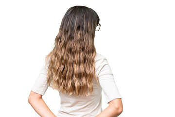 Young caucasian woman over isolated background in back position and looking back