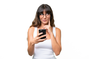 Young caucasian woman over isolated background using mobile phone and thinking