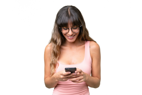 Young caucasian woman over isolated background sending a message with the mobile